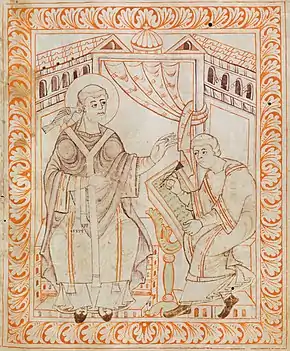 Two tonsured men, one with a dove on his shoulders, and the other writing a codex