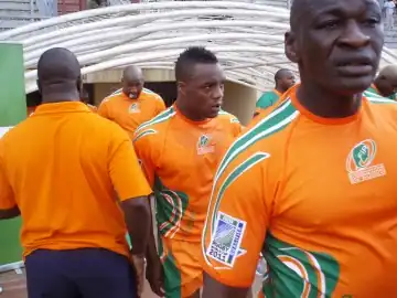 A close-up shot of the Ivory Coast players, in their country's orange jerseys, entering the field from the dressing room tunnel