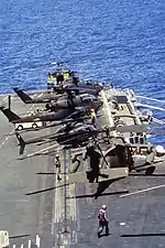 US Army Sikorsky UH-60 Black Hawk, Bell AH-1 Cobra and Bell OH-58 Kiowa helicopters on deck of the US Navy aircraft carrier USS Dwight D. Eisenhower (CVN-69) off Haiti, 1994.